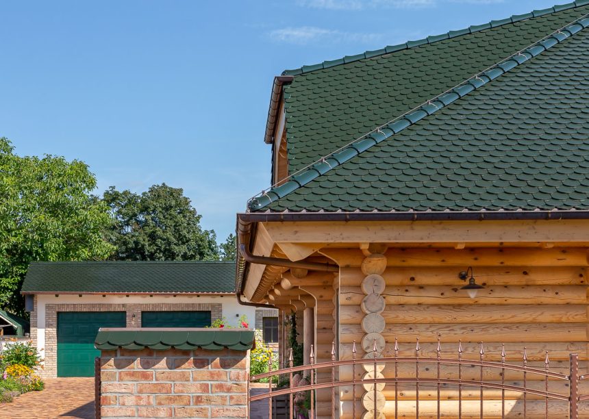 Seitliches Detail eines Holzhauses mit Biberschwanzziegel in der Farbe tannengrün auf dem Dach