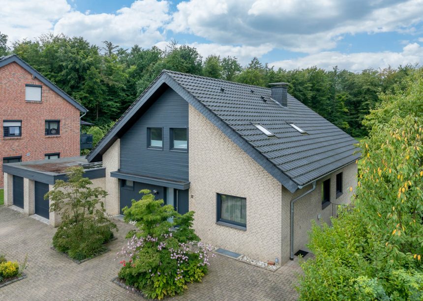 Saniertes Klinkerhaus mit Klassiker J11v im modernen altschwarz auf dem Satteldach in der Gesamtansicht aus der Luft