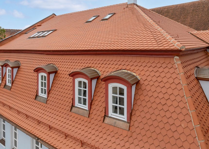 Mehrfamilienhaus mit Bibern in Rautespitz im traditionellen naturrot gedeckt mit Fokus auf die kunstvollen Gauben